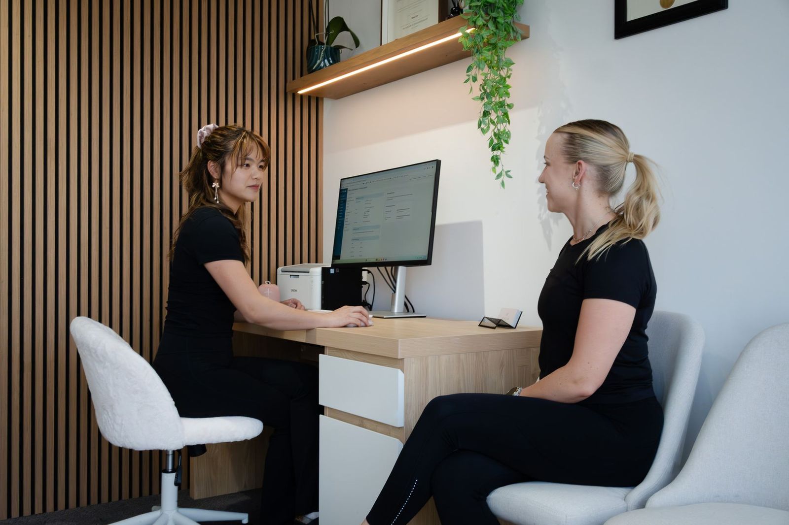 Diana Chen reviewing a client's assessment at the clinic desk